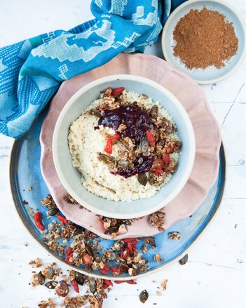 Auf dem Foto ist eine Schale mit Hirse-Porridge zu sehen. Darauf und davor ist Superfood Granola verstreut. | © SONNENTOR