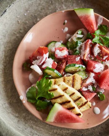 Auf dem Foto sieht man einen Teller mit Tomatensalat mit Wassermelonen. Darauf ist frische Petersilie zu sehen. | © SONNENTOR